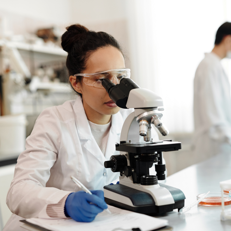 Women scientist looking in microscope